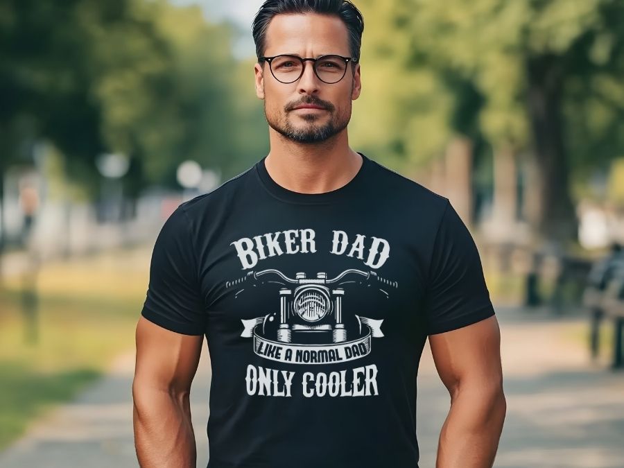 Funny Dad T-Shirts category image featuring a model wearing a biker-themed t-shirt that reads 'Biker Dad Like a Normal Dad Only Cooler'.