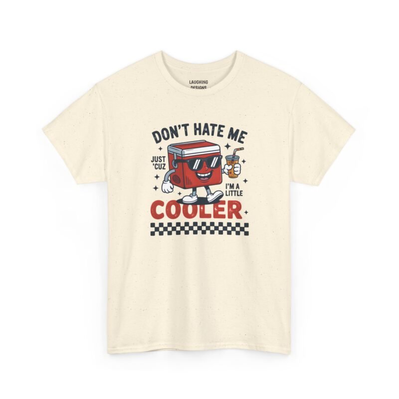 Funny t-shirt with a cartoon red drink cooler mascot wearing sunglasses and holding a drink, surrounded by text reading "DON'T HATE ME JUST 'CUZ I'M A LITTLE COOLER" with a black-and-white checkered banner at the bottom, printed on a Natual Cream color cotton shirt.
