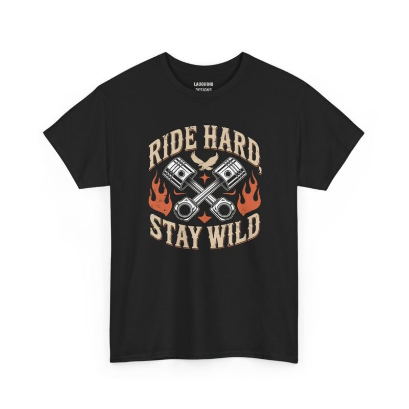 Vintage motorcycle t-shirt design featuring crossed engine pistons, an eagle, and orange flames surrounded by the text "RIDE HARD" and "STAY WILD" in a distressed retro font, printed on a Black color cotton shirt.