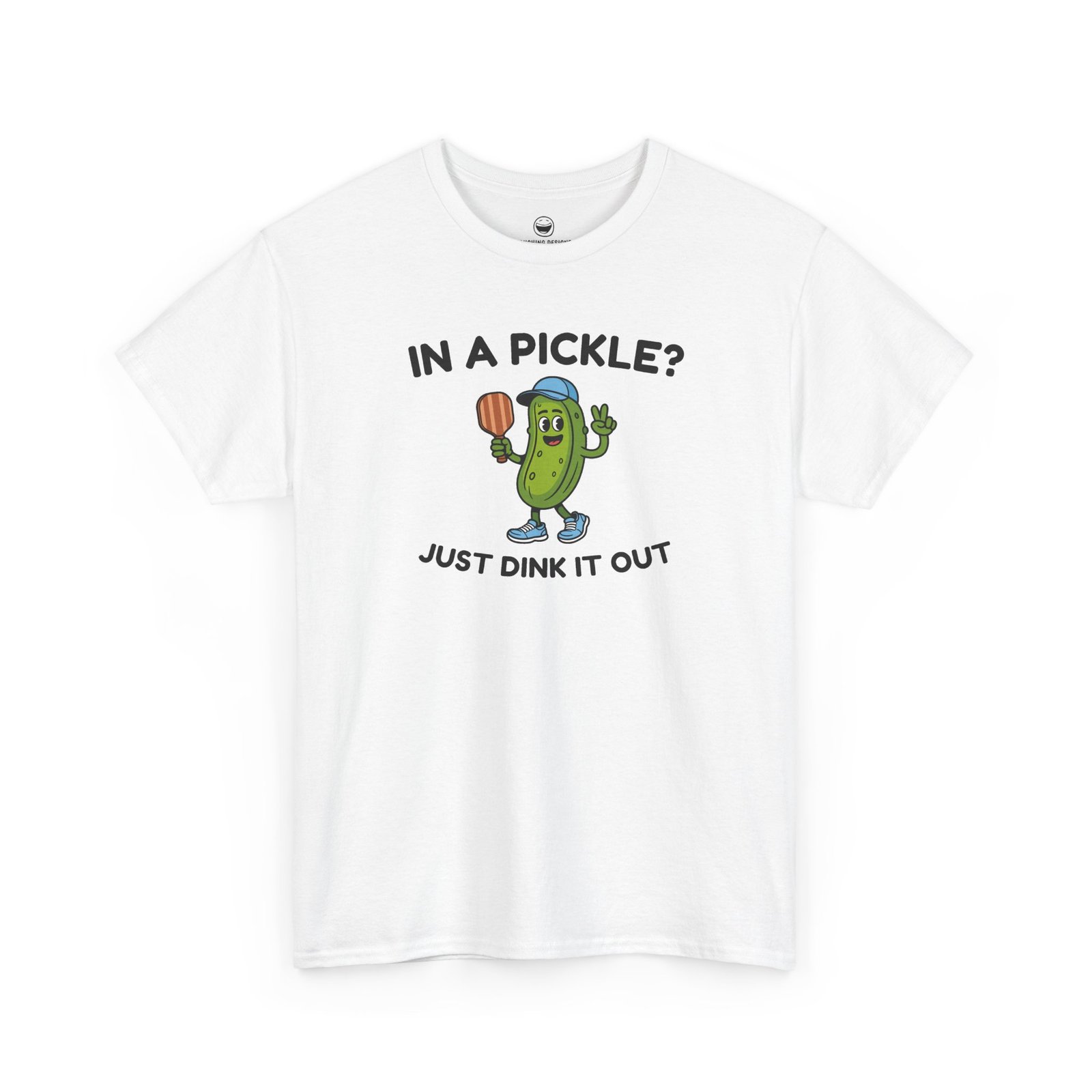 Funny Pickleball T-Shirt with a cartoon pickle character wearing a cap and holding a paddle between text reading "IN A PICKLE? JUST DINK IT OUT", printed on a White color cotton shirt.